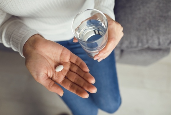 Patient taking antibiotic treatment pill for peirodontal disease