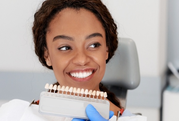 Woman smiling during porcelain veneer cosmetic dentistry treatment