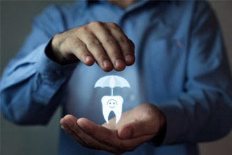 Man holding a graphic of a tooth