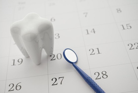 a model of a tooth on a calendar