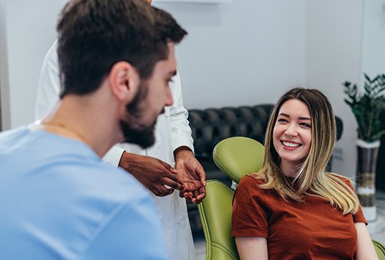 Happy dentist and patient engaged in conversation