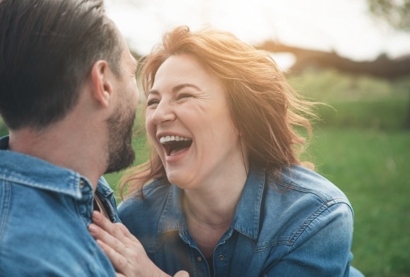 Woman smiling enjoying dental implant denture