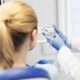 Dentist talking to patient during initial dental implant consultation