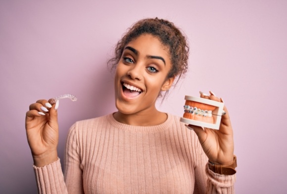 Woman smiling after receiving the answers to Invisalign frequently asked questions