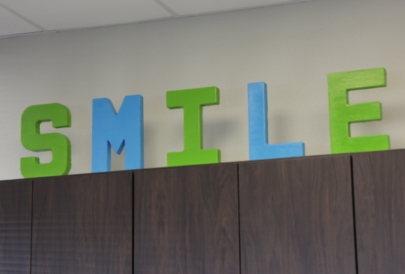 Sign reading smile on top of counter