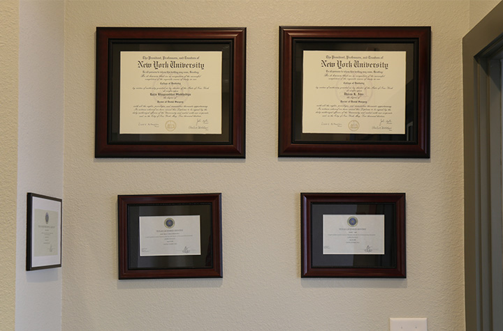 Dentist diplomas on dental office wall