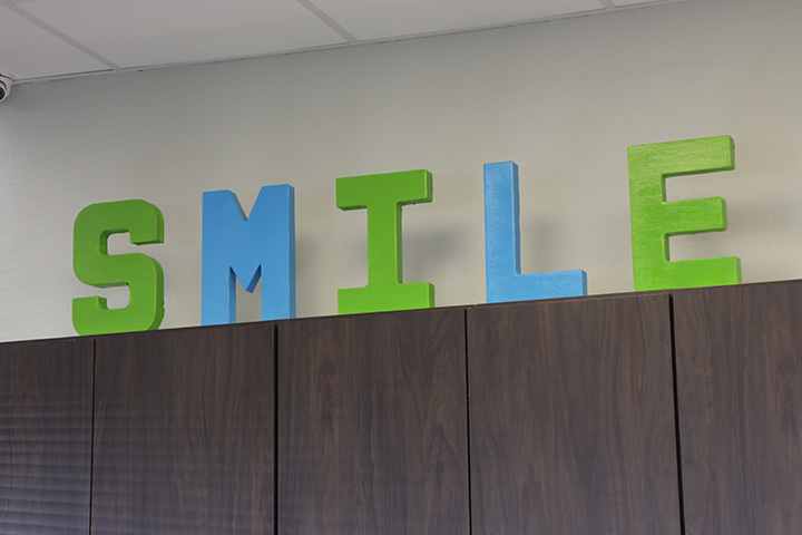 Sign reading smile on top of cabinets