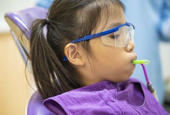 Young patient receiving fluoride treatment for children