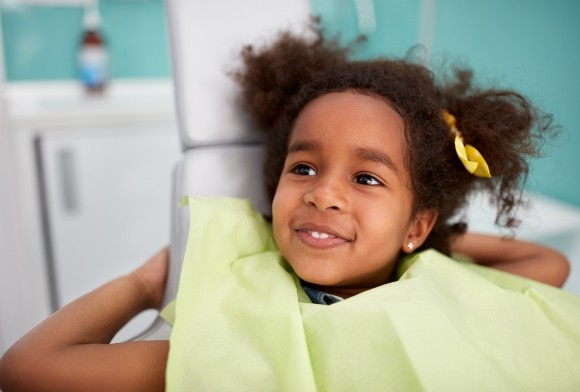 Child smiling during children's dentistry visit