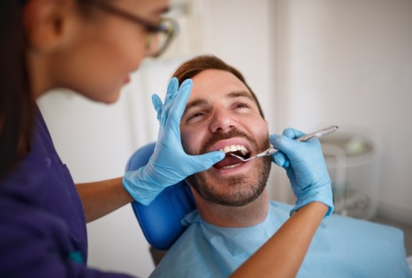 Man receiving oral cancer screening