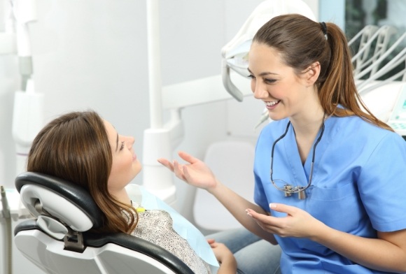 Patient talking to dental team member about the importance of not neglecting oral health