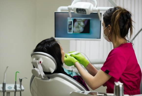 Dental teamn member using intraoral camera to capture images