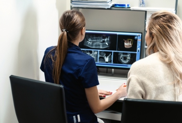 Dental team members looking at digital x-rays