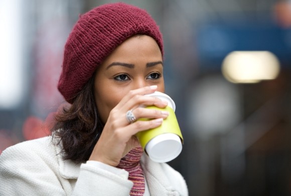 Woman drinking coffee which can stain teeth