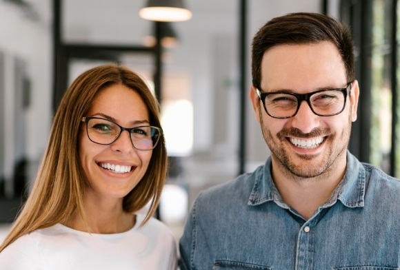 Man and woman enjoying bright smiles after teeth whitening