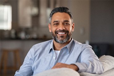 Man smiling after undergoing teeth whitening 