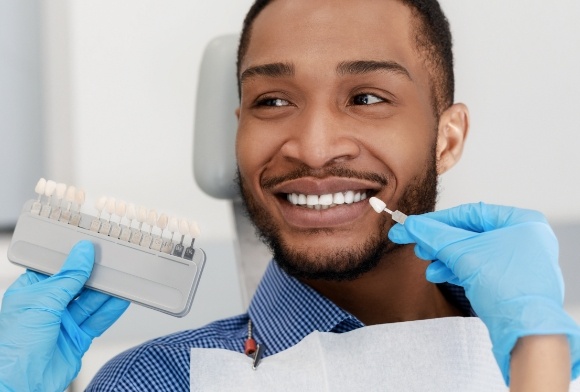 Man smiling during porcelain veneer procedure