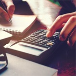 Woman calculating cost of veneers in Carrollton