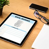 Dental insurance form on a tablet on a desk