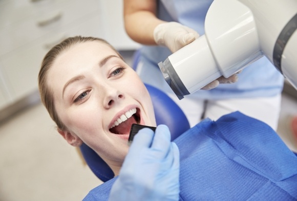 Patient receiving an x-ray prior to wisdom tooth extraction