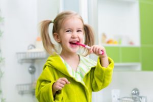 little girl brushing teeth