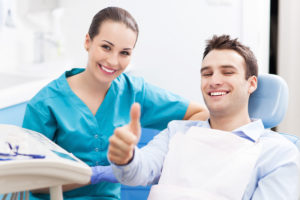 Man giving thumbs up at dentist office