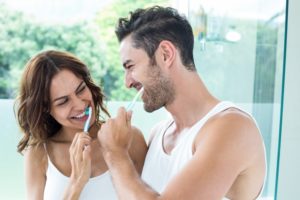 couple brushing teeth