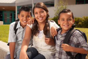 Children smiling outside of school