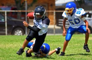 Boy playing football in pads.