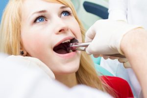 girl getting tooth extracted