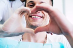 young man smiling in dentist chair