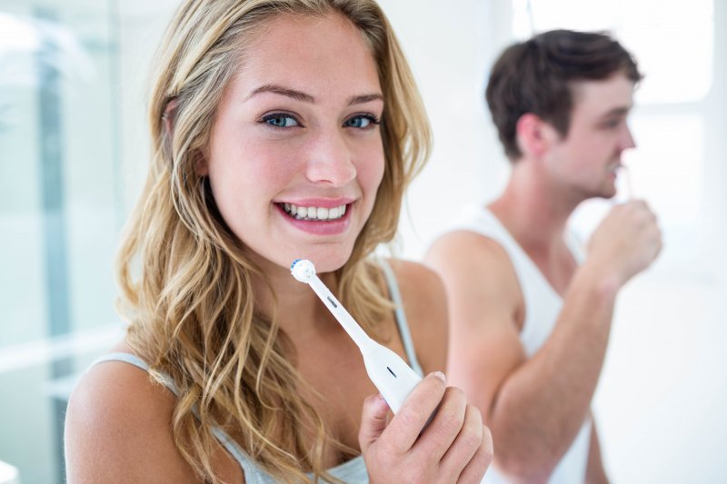 Young couple brushing their teeth together