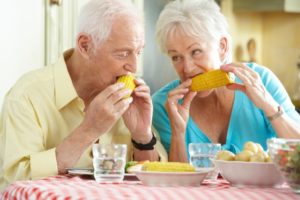 mature couple eating corn on the cob
