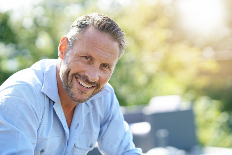 man smiling after root canal therapy in Carrollton