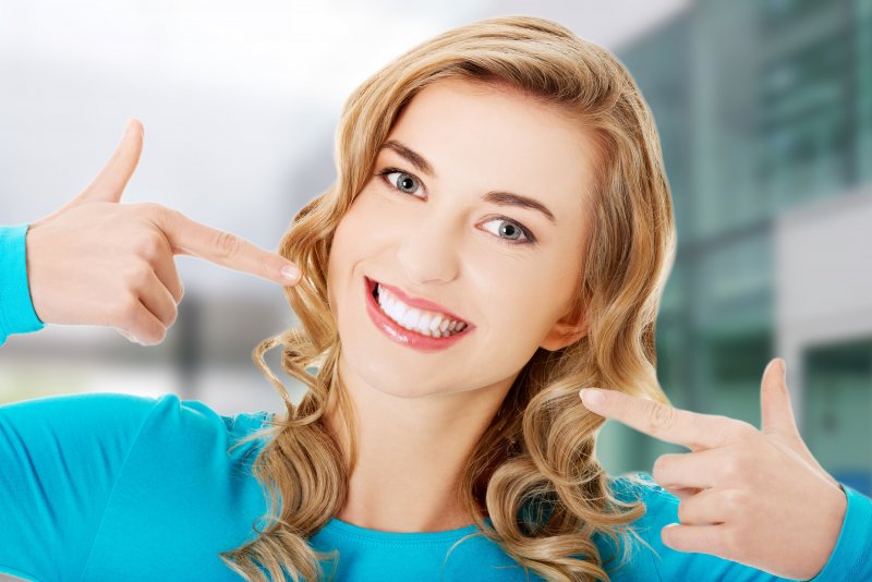 woman pointing at her white smile in Carrollton