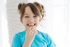 a child showing their gapped smile from missing a tooth