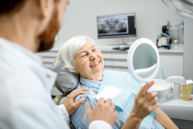 An older woman admiring her implants