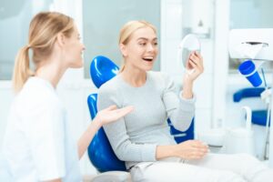 Woman loving her results after a cosmetic dental treatment